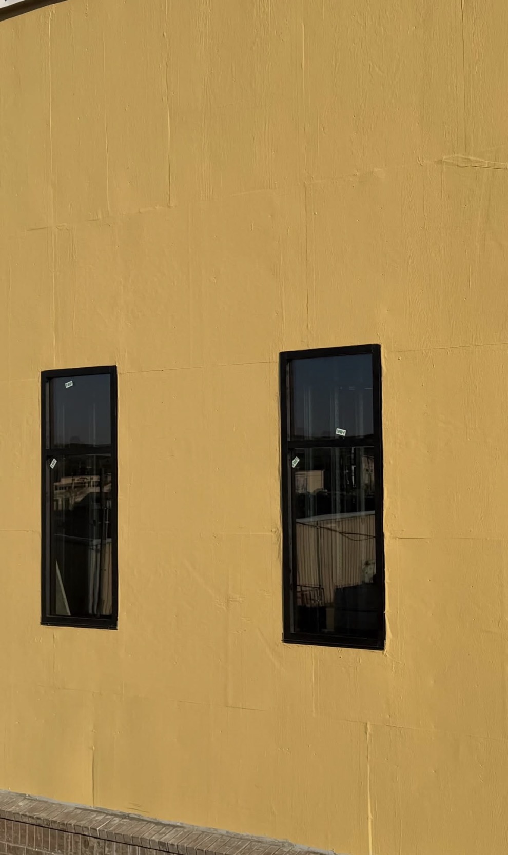Tall vertical units set into stucco — precision install on elevated wall