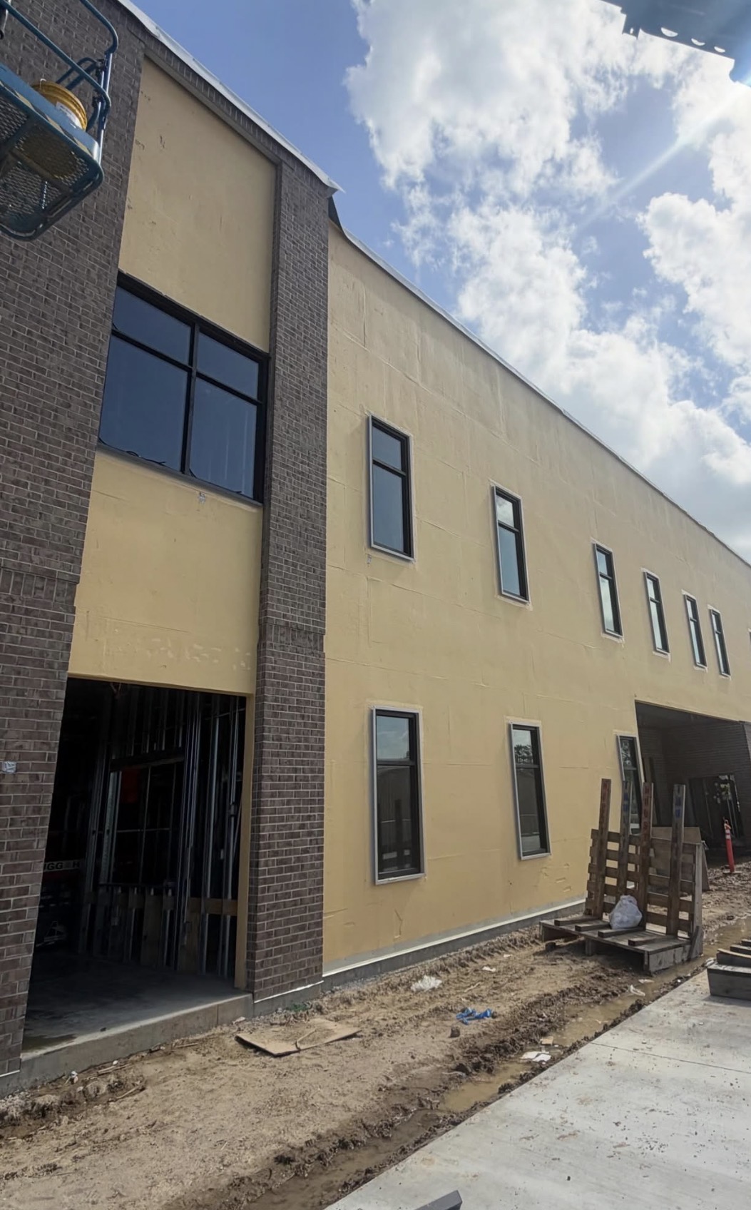Brick & stucco facade — punched window openings ready for glazing